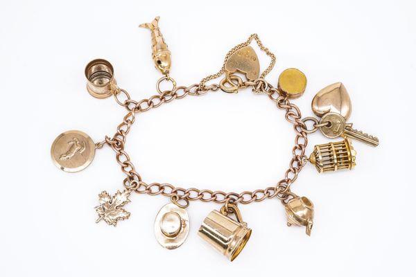 A 9CT GOLD CURB LINK CHARM BRACELET