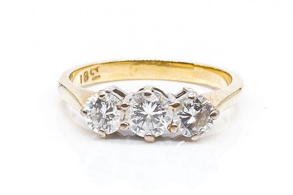 A GOLD AND DIAMOND THREE STONE RING