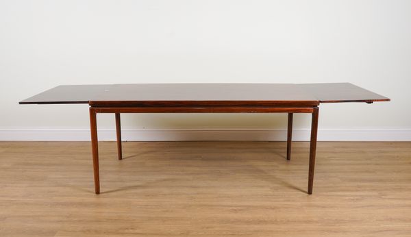 ATTRIBUTED TO JOHANNES ANDERSEN; A MID 20TH CENTURY DANISH ROSEWOOD RECTANGULAR EXTENDING DINING TABLE (9)