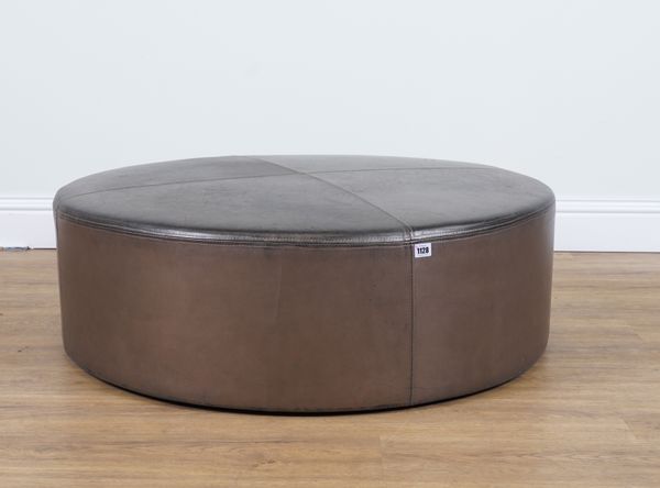 A MODERN CIRCULAR LEATHER UPHOLSTERED FOOTSTOOL