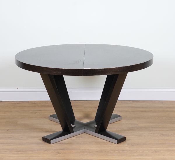 A HARDWOOD CIRCULAR EXTENDING DINING TABLE