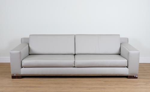 A LARGE GREY UPHOLSTERED FOUR SEAT SOFA