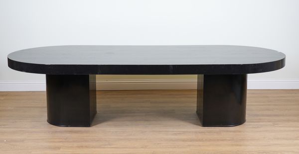 AN EBONISED ASH OVAL DINING TABLE