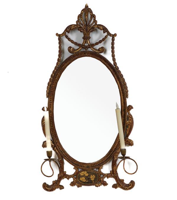 A GILT FRAMED GIRANDOLE OVAL MIRROR