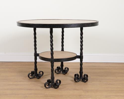 A MID 20TH CENTURY WROUGHT IRON BOUND MAHOGANY CIRCULAR DINING TABLE