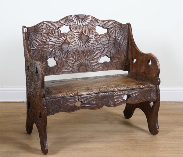 LIBERTY & CO LONDON; AN ARTS AND CRAFTS JAPANESE CARVED SETTLE