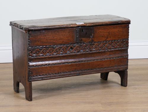 A SMALL 17TH CENTURY AND LATER CARVED OAK SIX PLANK COFFER