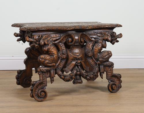 A 19TH CENTURY ITALIAN CARVED WALNUT HALL BENCH WITH GROTESQUE BEAST DECORATION