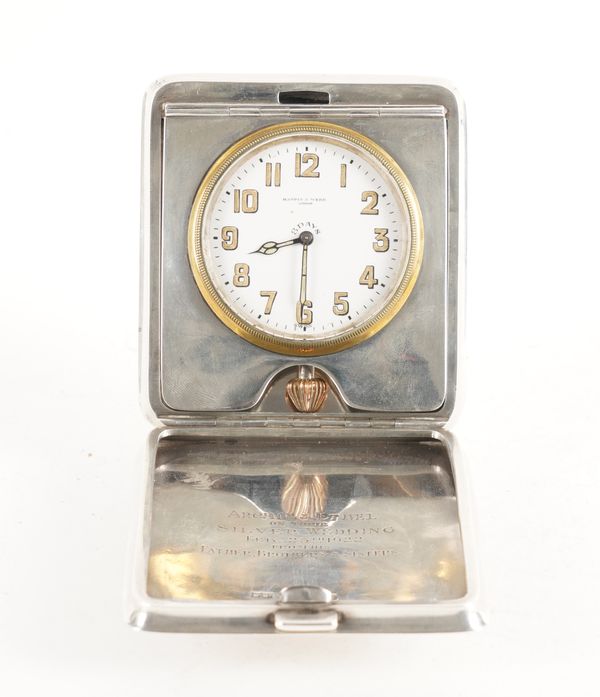 A SILVER RECTANGULAR CASED FOLDING TRAVELLING CLOCK