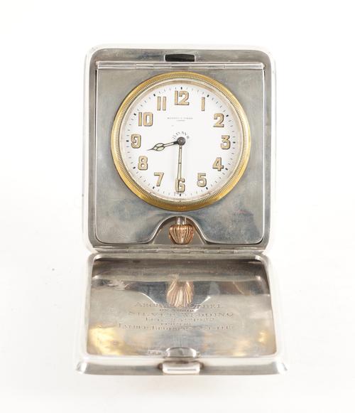 A SILVER RECTANGULAR CASED FOLDING TRAVELLING CLOCK