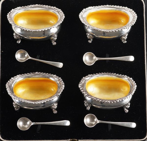 A SET OF FOUR SILVER AND YELLOW ENAMELLED SALTS