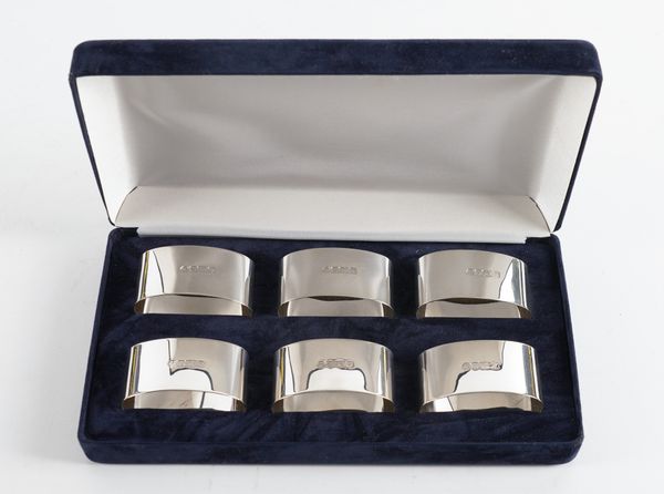 A SET OF SIX SILVER NAPKIN RINGS