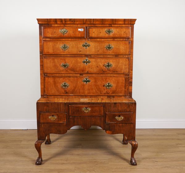 A GEORGE I FIGURED WALNUT FIVE DRAWER CHEST ON STAND