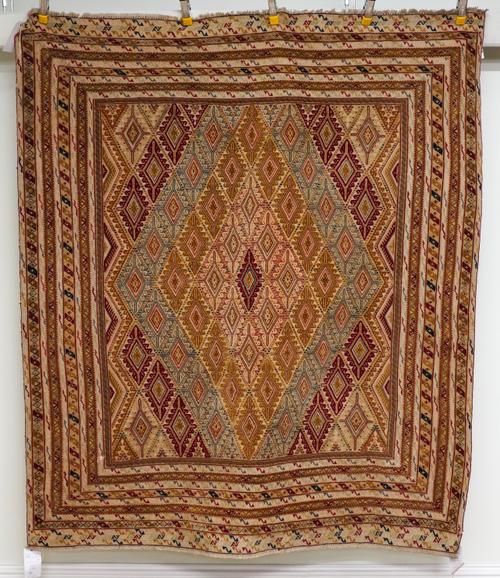 AN AFGHAN EMBROIDERED AND PILED RUG