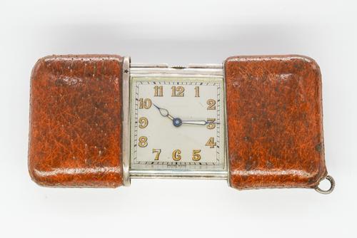 A MOVADO PIG SKIN CASED SILVER RECTANGULAR FOLDING PURSE WATCH