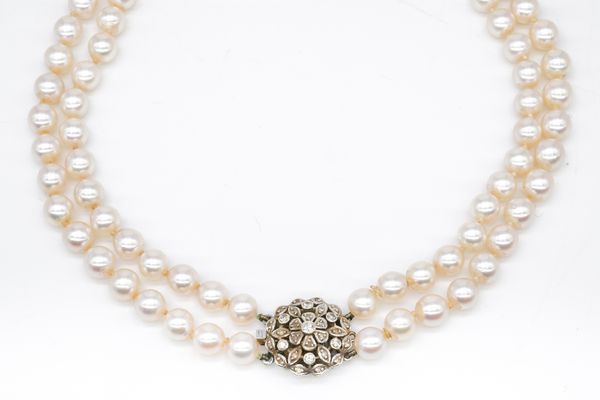 A TWO ROW NECKLACE OF UNIFORM CULTURED PEARLS ON A DIAMOND SET CLASP