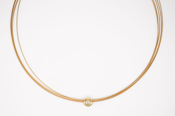 A GOLD AND COLOURLESS GEM SET NECKLACE