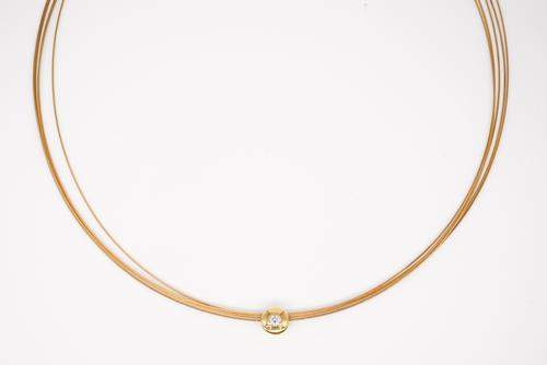 A GOLD AND COLOURLESS GEM SET NECKLACE