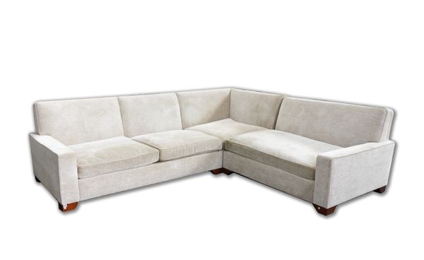 KINGCOME; A LARGE CREAM UPHOLSTERED CORNER SOFA