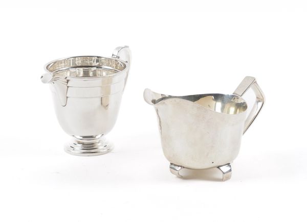 TWO SILVER MILK JUGS AND A SILVER MOUNTED BOTTLE COASTER (3)