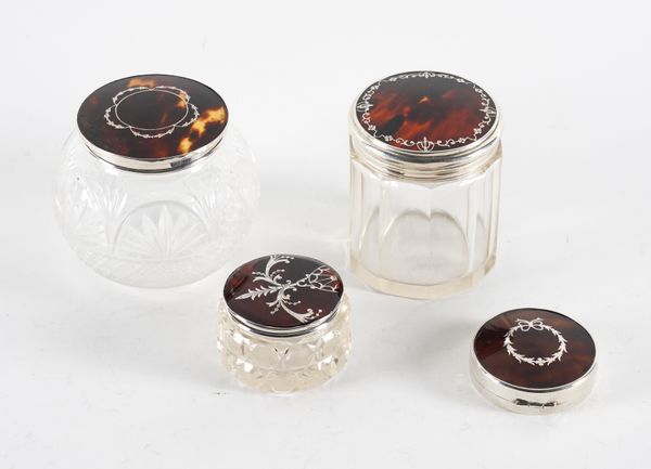 THREE SILVER AND TORTOISESHELL LIDDED GLASS JARS  AND ONE SILVER AND TORTOISESHELL MOUNTED CIRCULAR COMPACT (4)