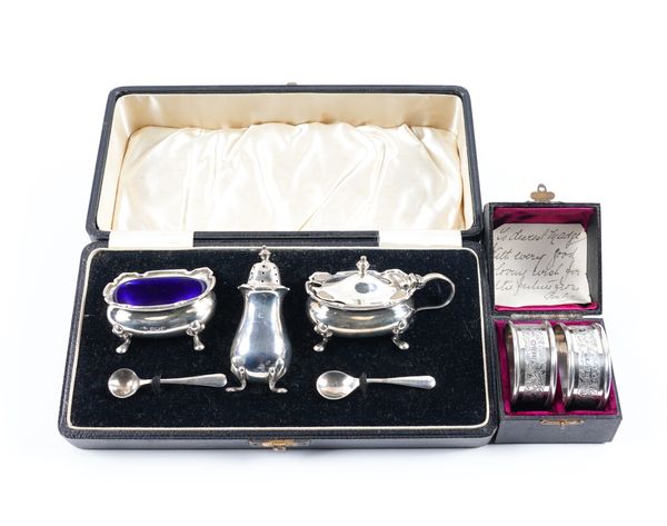 A SILVER THREE PIECE COPNDIMENT SET AND A PAIR OF SILVER NAPKIN RINGS