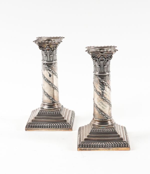 A PAIR OF SILVER CANDLESTICKS