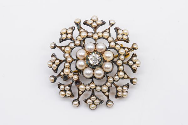 A LATE VICTORIAN GOLD BACKED AND SILVER SET DIAMOND AND SEED PEARL BROOCH