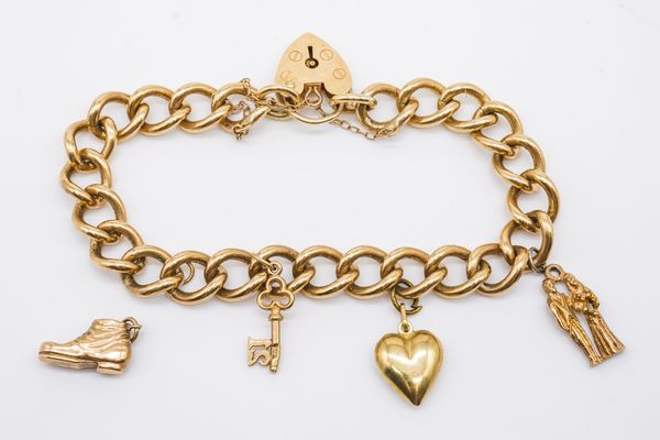 A 9CT GOLD CURB LINK CHARM BRACELET