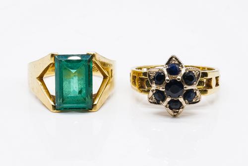 AN 18CT GOLD AND SAPPHIRE SEVEN STONE CLUSTER RING AND A GOLD AND SYNTHETIC GREEN SPINEL SET SINGLE STONE RING (2)