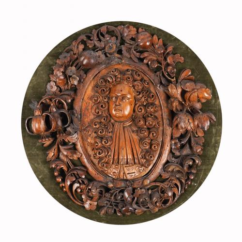 A CHARLES II CARVED LIMEWOOD PORTRAIT PLAQUE
