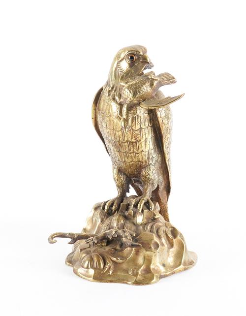 A GILT-METAL INKWELL IN THE FORM OF A BIRD OF PREY
