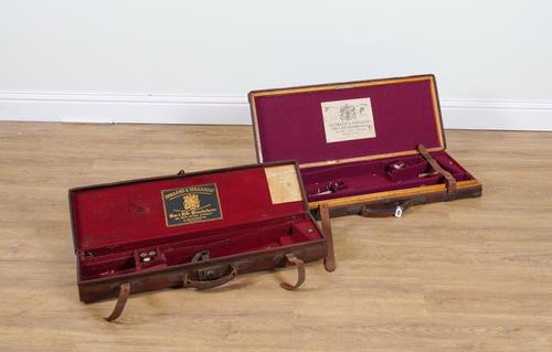 HOLLAND & HOLLAND: AN OAK LINED AND LEATHER BOUND DOUBLE GUN CASE AND ANOTHER SINGLE GUN CASE (2)