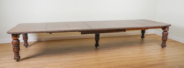 EDWARDS & ROBERTS; A CARVED OAK EXTENDING DINING TABLE