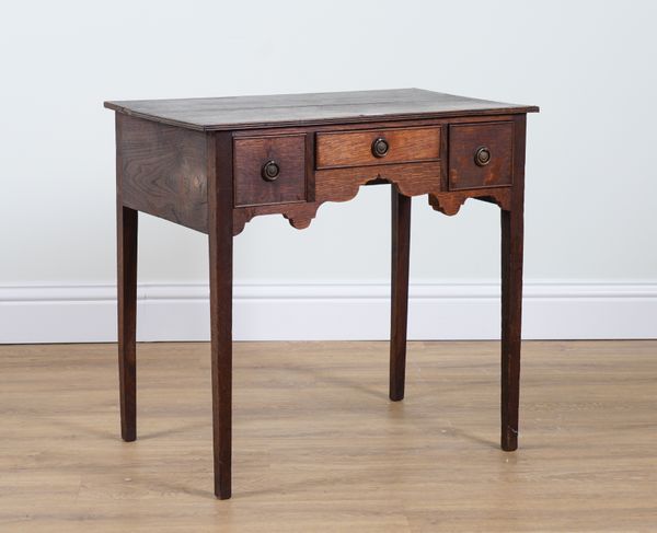 A GEORGE III OAK THREE DRAWER LOWBOY