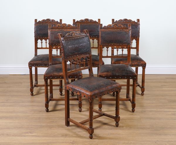 A SET OF SIX EARLY 20TH CENTURY FRENCH STAINED BEECH AND EMBOSSED LEATHER DINING CHAIRS (6)