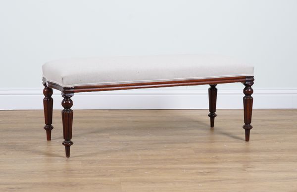 A MAHOGANY FRAMED RECTANGULAR FOOTSTOOL ON REEDED SUPPORTS