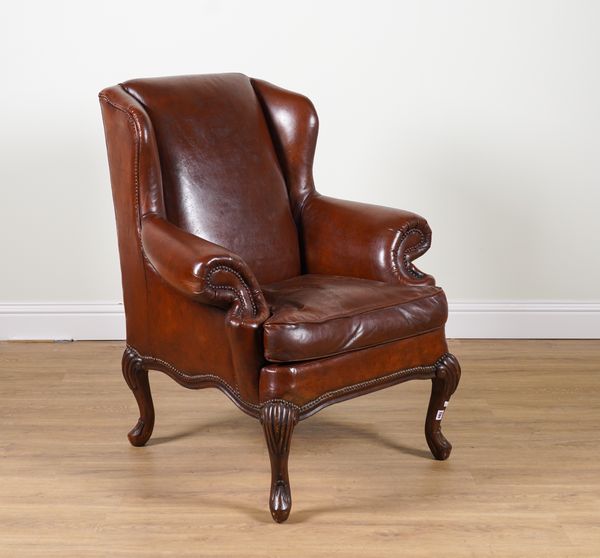 A GEORGE III STYLE WINGBACK ARMCHAIR WITH TAN LEATHER UPHOLSTERY