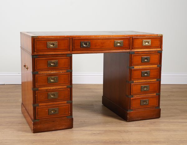 A CAMPAIGN STYLE YEW WOOD ELEVEN DRAWER PEDESTAL DESK