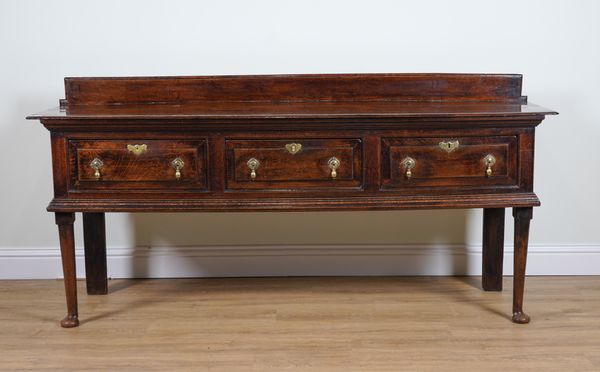 A MID 18TH CENTURY OAK THREE DRAWER DRESSER BASE ON PAD FEET