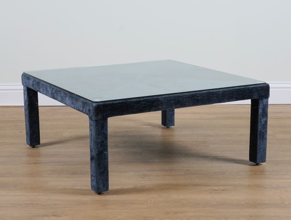 A DARK BLUE VELVET UPHOLSTERED SQUARE GLASS TOPPED COFFEE TABLE