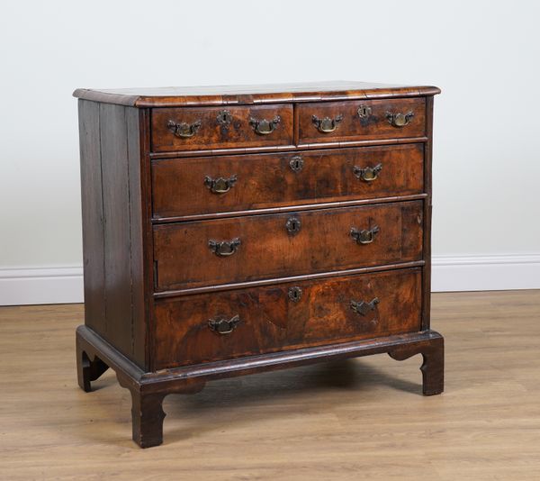 A GEORGE I AND LATER CROSS BANDED WALNUT FIVE DRAWER CHEST