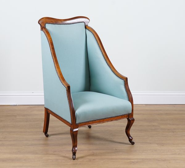 AN EDWARDIAN MAHOGANY FRAMED WINGBACK ARMCHAIR