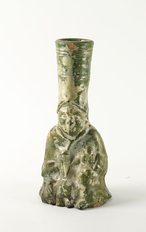 A CHINESE POTTERY GREEN GLAZED  FIGURAL CANDLE HOLDER