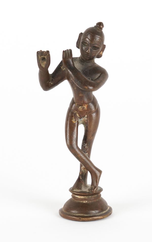 A SMALL INDIAN BRONZE FIGURE OF KRISHNA