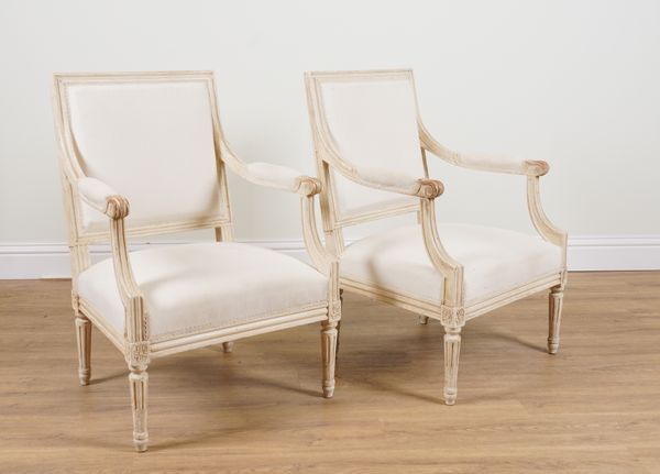 A PAIR OF LOUIS XVI STYLE WHITE PAINTED OPEN ARMCHAIRS (2)