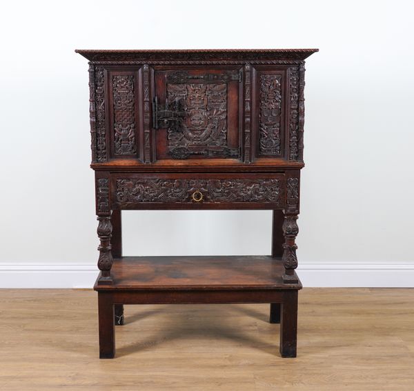 A 17TH CENTURY STYLE CARVED OAK CABINET