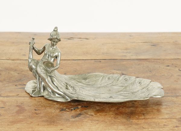 AN ART NOUVEAU PEWTER PEACOCK FEATHER FIGURAL DISH