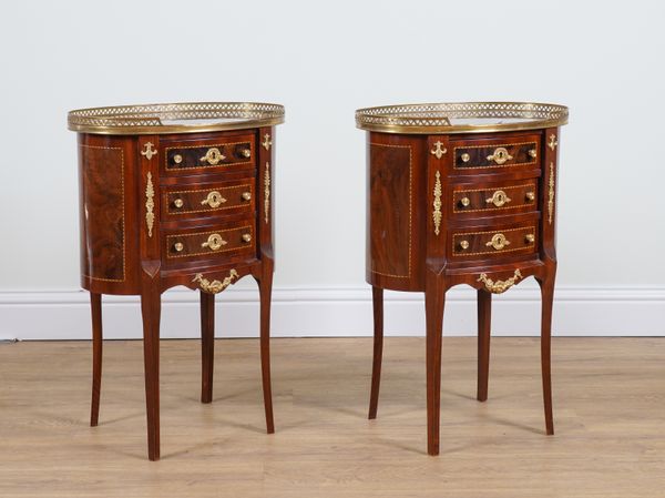 A PAIR OF FRENCH GILT METAL MOUNTED WALNUT OVAL THREE DRAWER SIDE CHESTS (2)