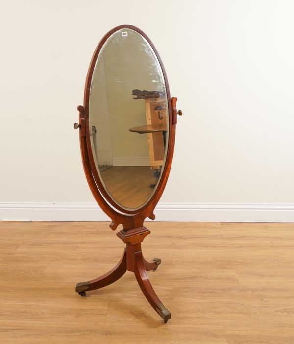 AN EDWARDIAN MAHOGANY OVAL CHEVAL MIRROR ON TRIPOD BASE